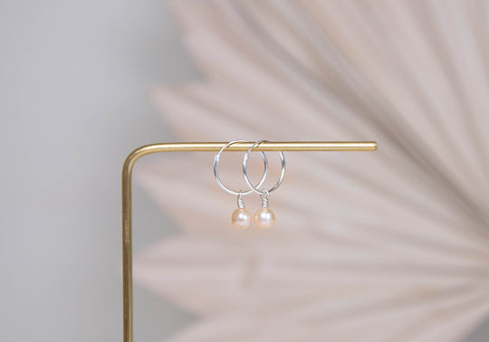 Orbit sterling silver hoops with pink peach pearl charm earrings