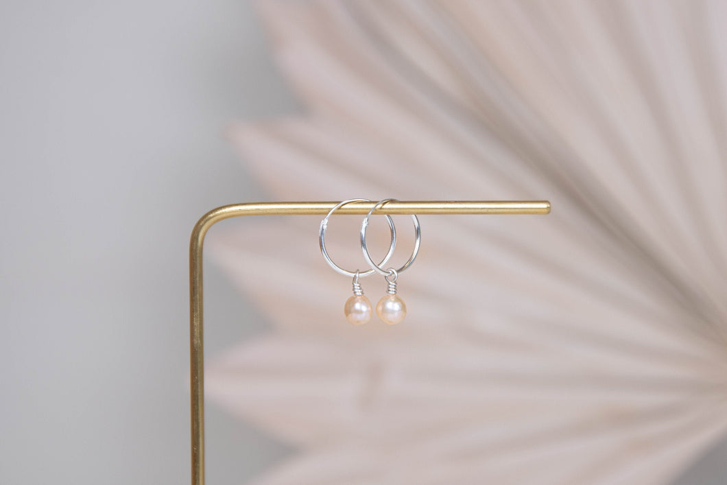 Orbit sterling silver hoops with pink peach pearl charm earrings
